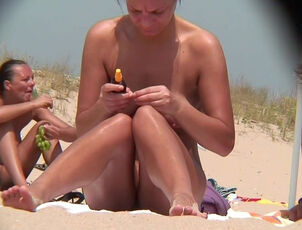 Yoummy clean-shaved honeypots on the beach filmed some stud